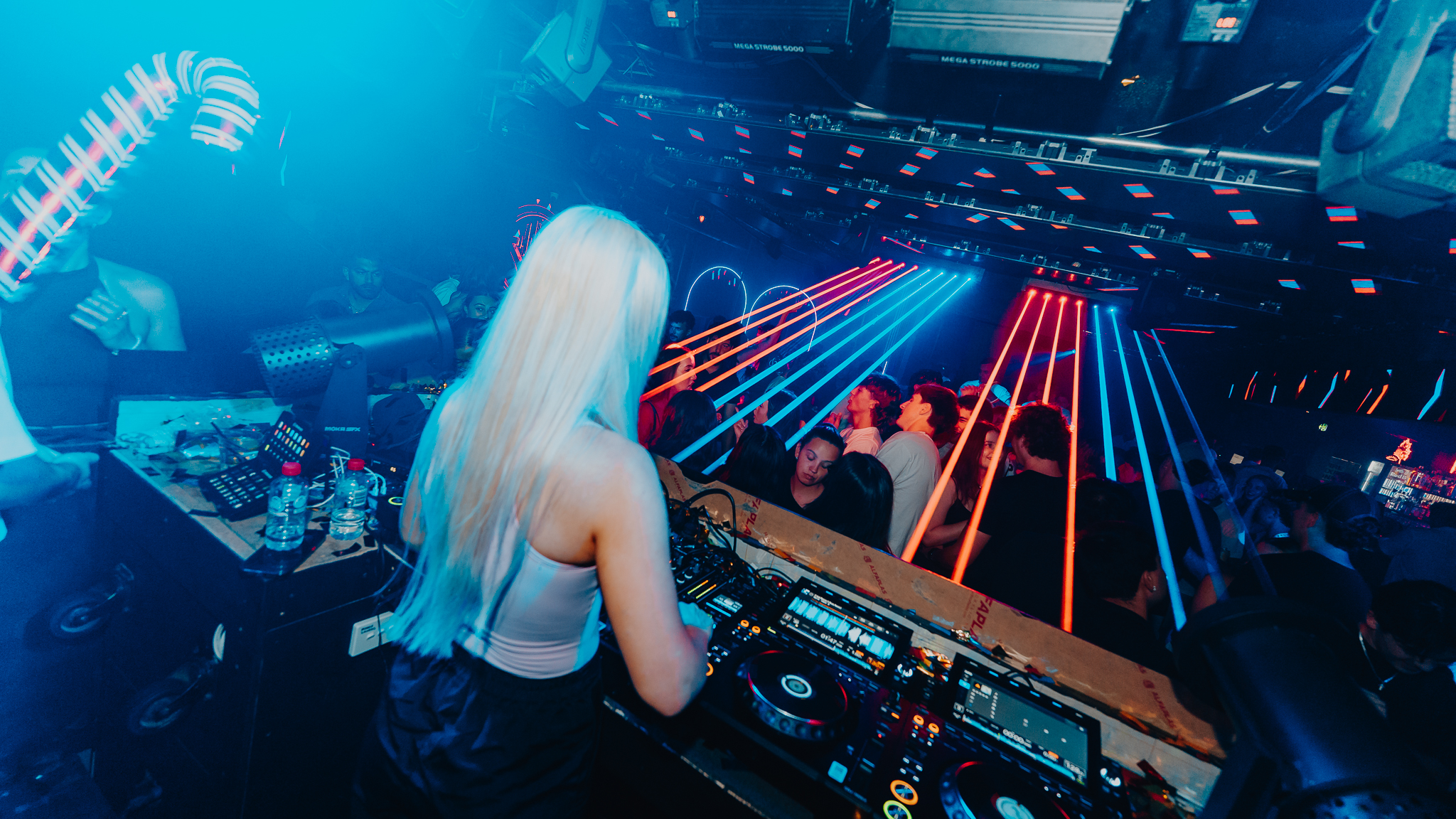 Female DJ overlooking crowd with laser show, Gold Coast